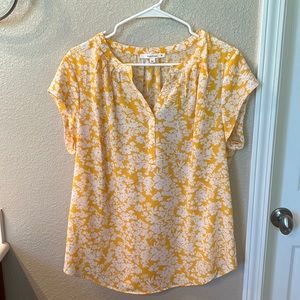 Woman’s yellow top.